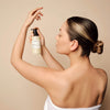 A woman using the Purifying Cream Oil Body Wash